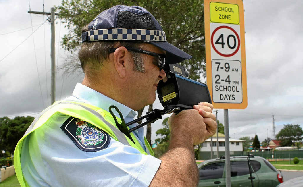 SLOW DOWN: Senior Constable Shane Montgomery shows that police can be hiding around any corner with a speed gun.